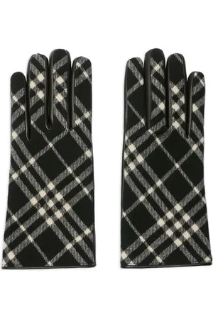 Luxury Check Wool Cashmere Gloves | Burberry Black/Calico Beige

Elevate your winter style with these iconic Check Wool Cashmere Gloves from Burberry. Crafted in Italy, these designer gloves feature a blend of premium wool and soft cashmere, backed with supple grainy calf leather on the palm for a secure grip. Finished with a logo-engraved metal stud and luxuriously lined in cashmere silk, these gloves offer supreme warmth and a press-stud closure for a perfect fit. Ideal for sophisticated warmth and an unmistakable heritage look.